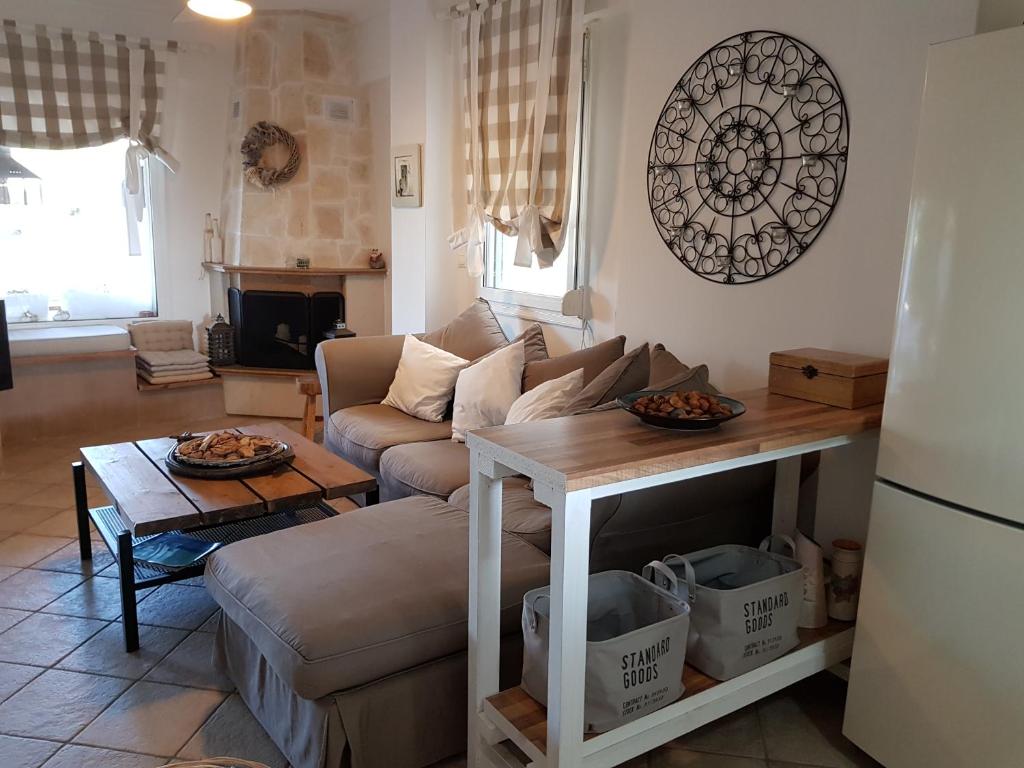a living room with a couch and a table at Cozy Cliff House in Nea Potidaea