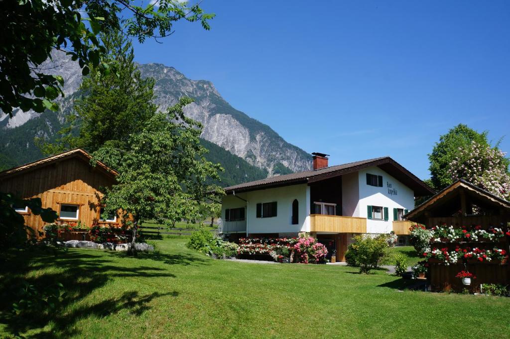 a house in a field with mountains in the background at Haus Angelika in Vandans