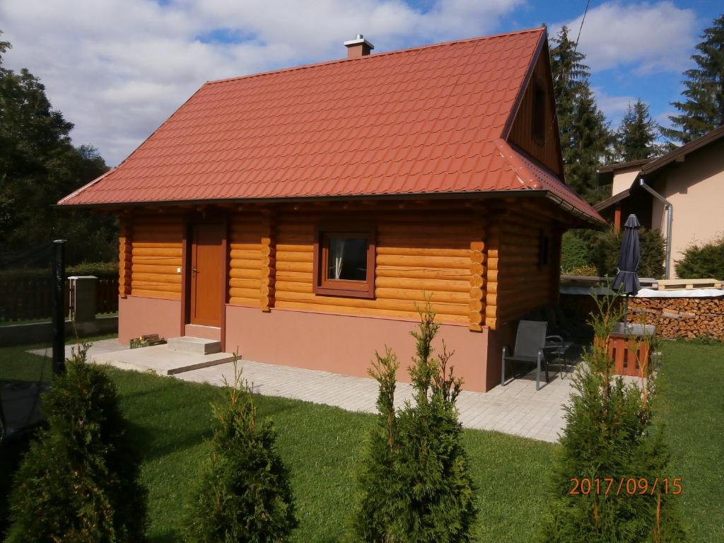 une cabane en rondins avec un toit rouge dans l'établissement Drevenica Silvia, à Liptovský Mikuláš