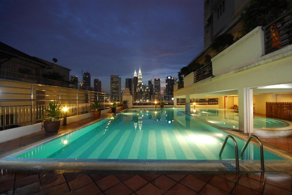 a large swimming pool with a city skyline in the background at Holiday Place Kuala Lumpur in Kuala Lumpur