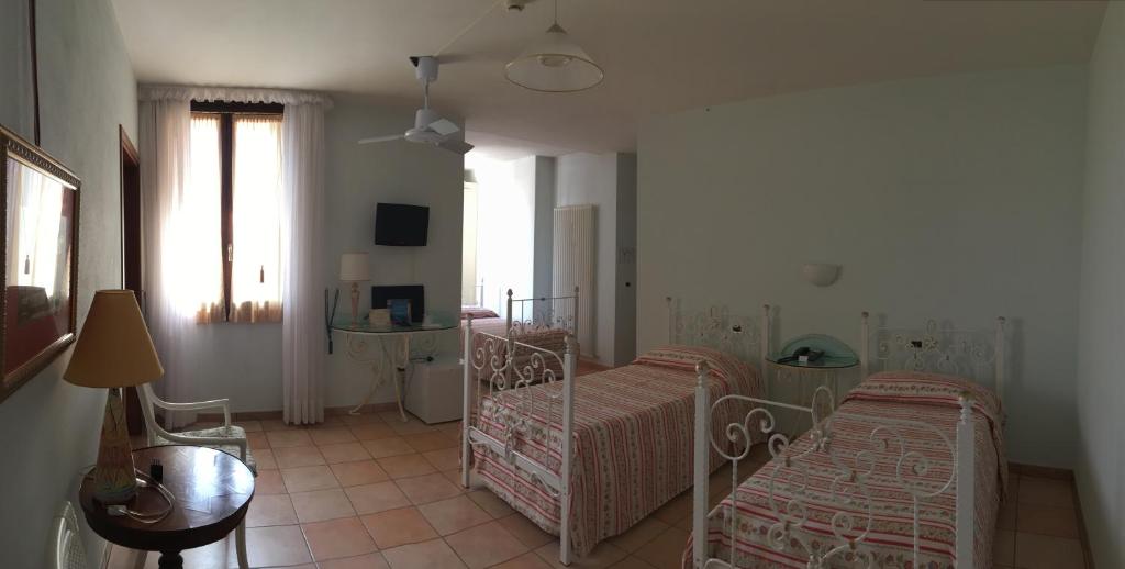 Postel nebo postele na pokoji v ubytování Villa Scalabrini