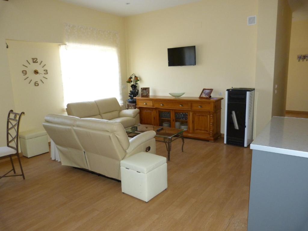 sala de estar con sofá y silla en Apartamento Zapatero en Trabanca