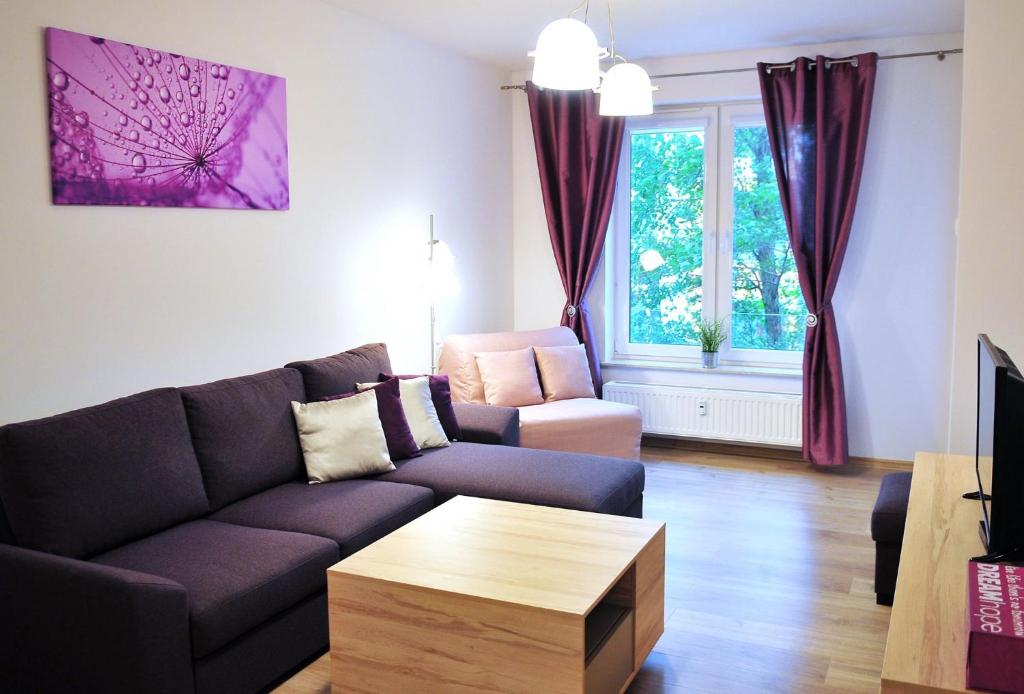 a living room with a couch and a coffee table at Polanki Sea Kolberg in Kołobrzeg