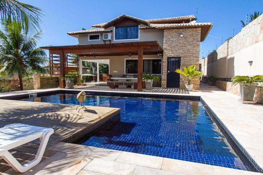 a swimming pool in front of a house at Casa Colina Pipa in Pipa