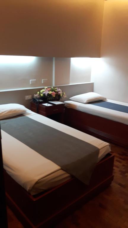 Postel nebo postele na pokoji v ubytování El Cielito Hotel - Baguio