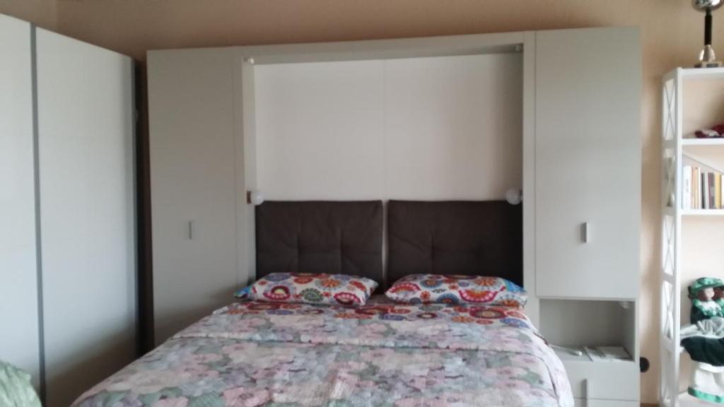 a bed with a headboard in a bedroom at Casa Margherita in Villar San Costanzo