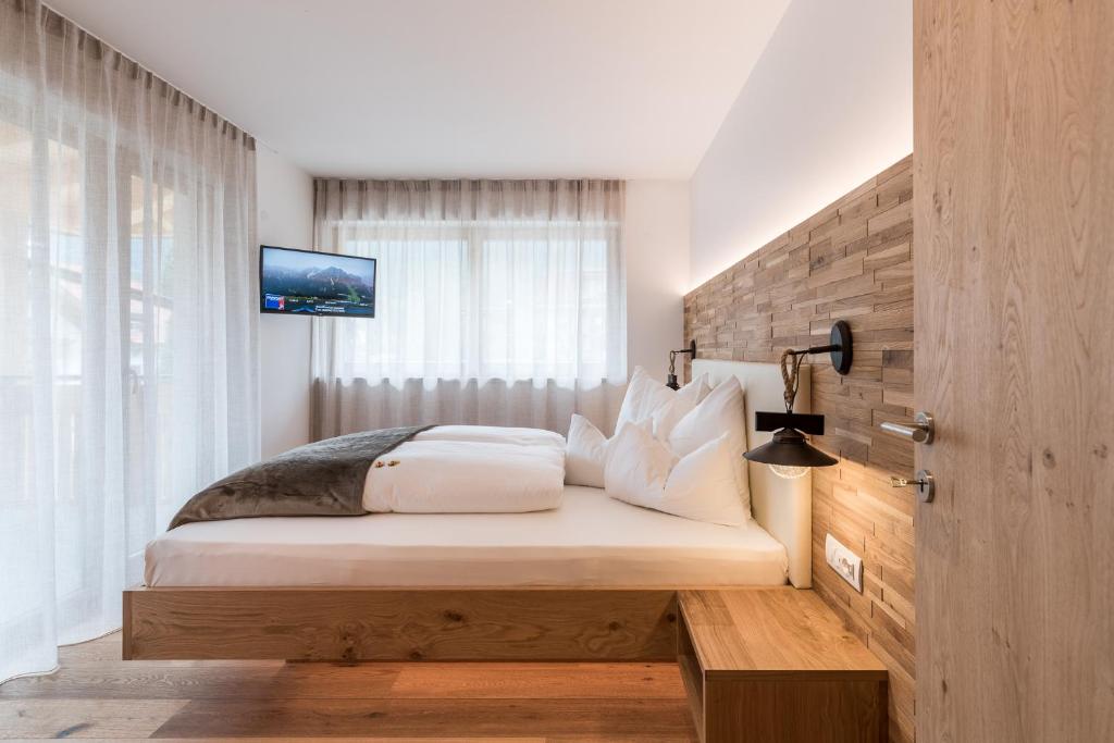 Postel nebo postele na pokoji v ubytování Hotel B&B Feldmessner