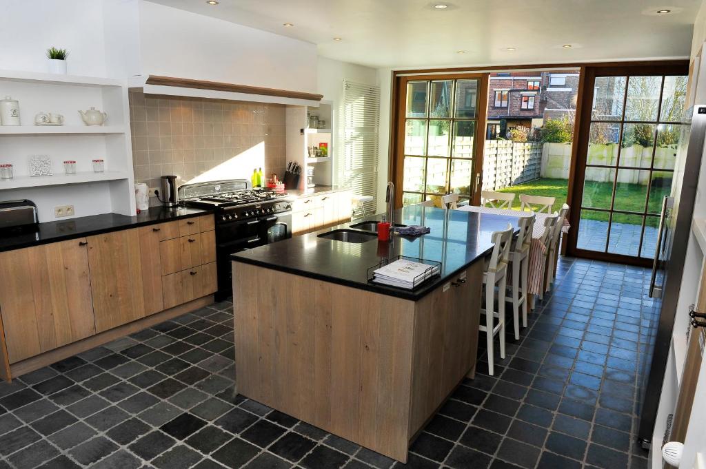 a kitchen with a large island with a counter top at Huize Ewoud in Bruges