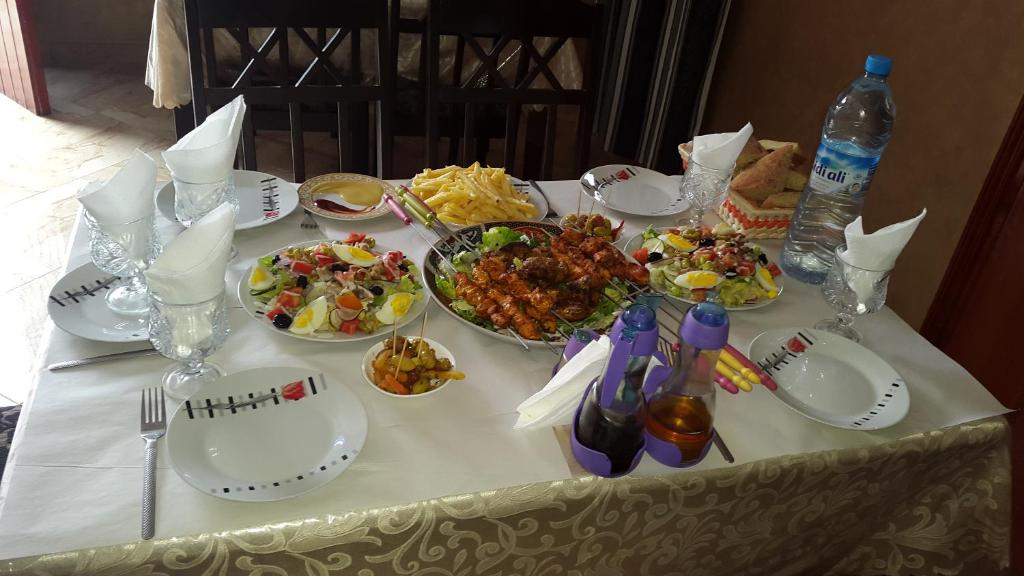 a table with plates and bowls of food on it at Hôtel Ajil Cascades D'ouzoud in Ouzoud