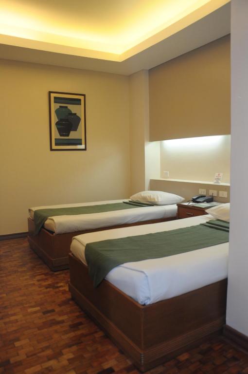 Postel nebo postele na pokoji v ubytování El Cielito Hotel - Baguio