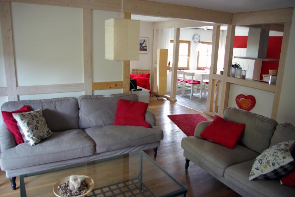 a living room with two couches and a table at Waldblick in Bleckede