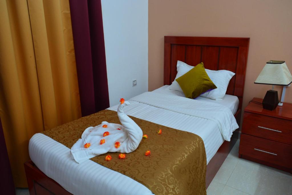 Postel nebo postele na pokoji v ubytování Al Karam Hotel Apartment