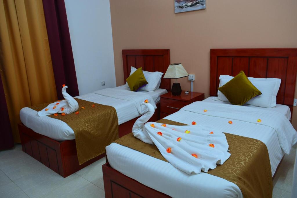 Postel nebo postele na pokoji v ubytování Al Karam Hotel Apartment