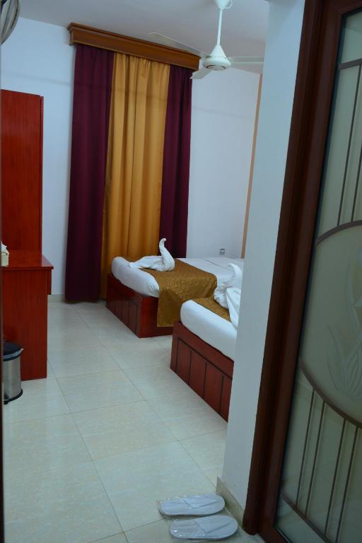 Postel nebo postele na pokoji v ubytování Al Karam Hotel Apartment