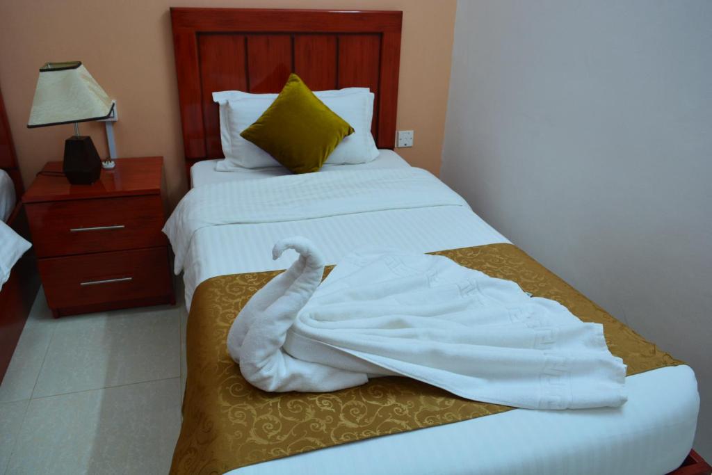 Postel nebo postele na pokoji v ubytování Al Karam Hotel Apartment