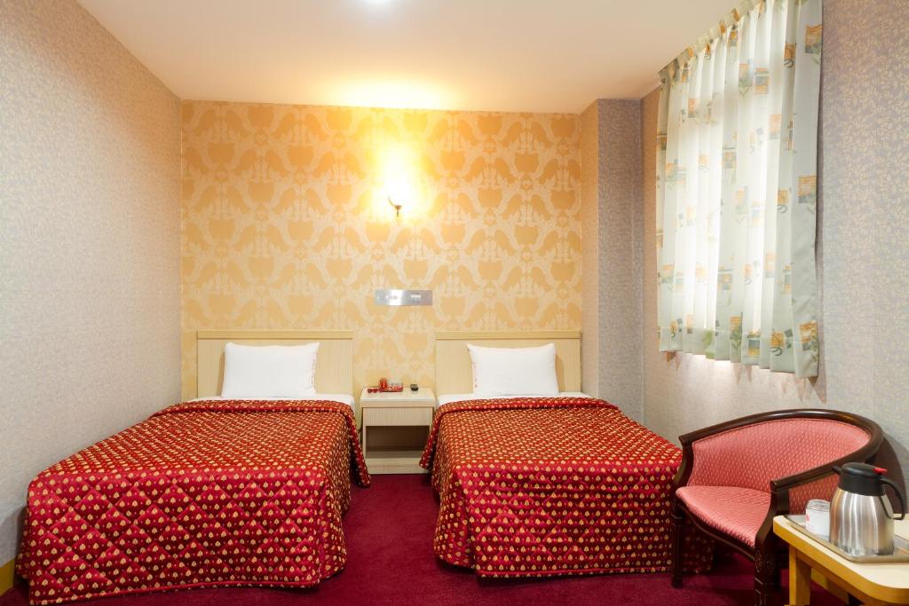 En eller flere senger på et rom på Songshan Hotel