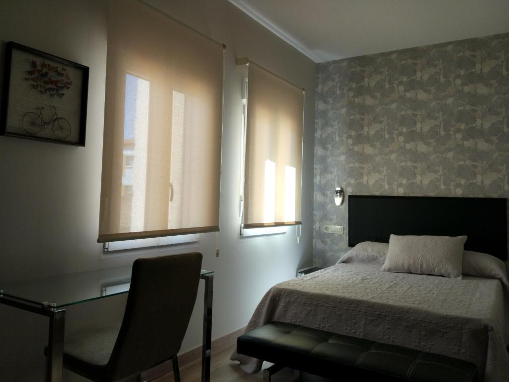 Postel nebo postele na pokoji v ubytování Apartamentos Mitreo