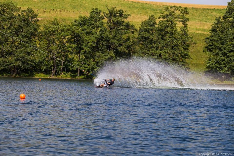 a person is water skiing in a lake at WOSiR Szelment in Jeleniewo