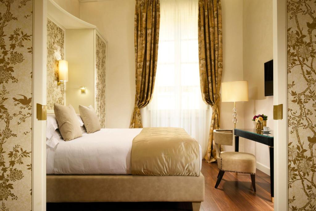 Posteľ alebo postele v izbe v ubytovaní San Firenze Suites & Spa