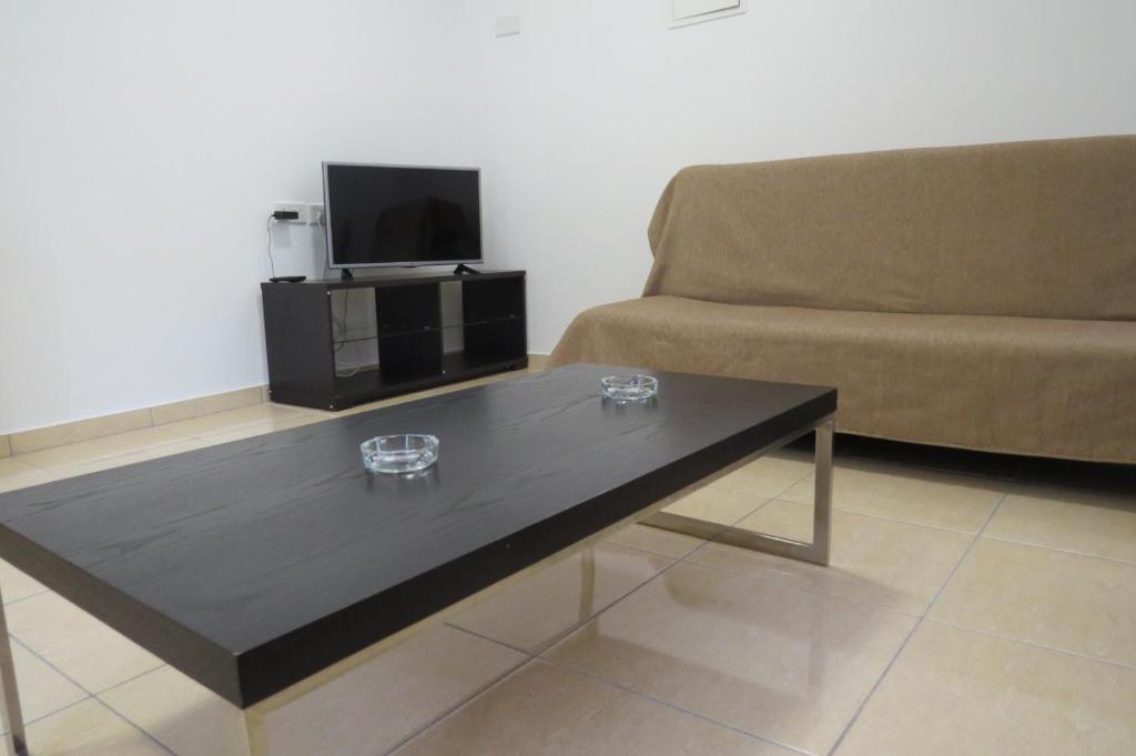 a black coffee table in a living room with a couch at River Apartments in Galata