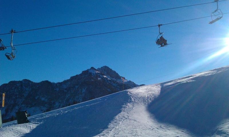 a person riding a ski lift on a snow covered slope at Apartment "Birgit" Sonnleitn/Nassfeld in Sonnenalpe Nassfeld