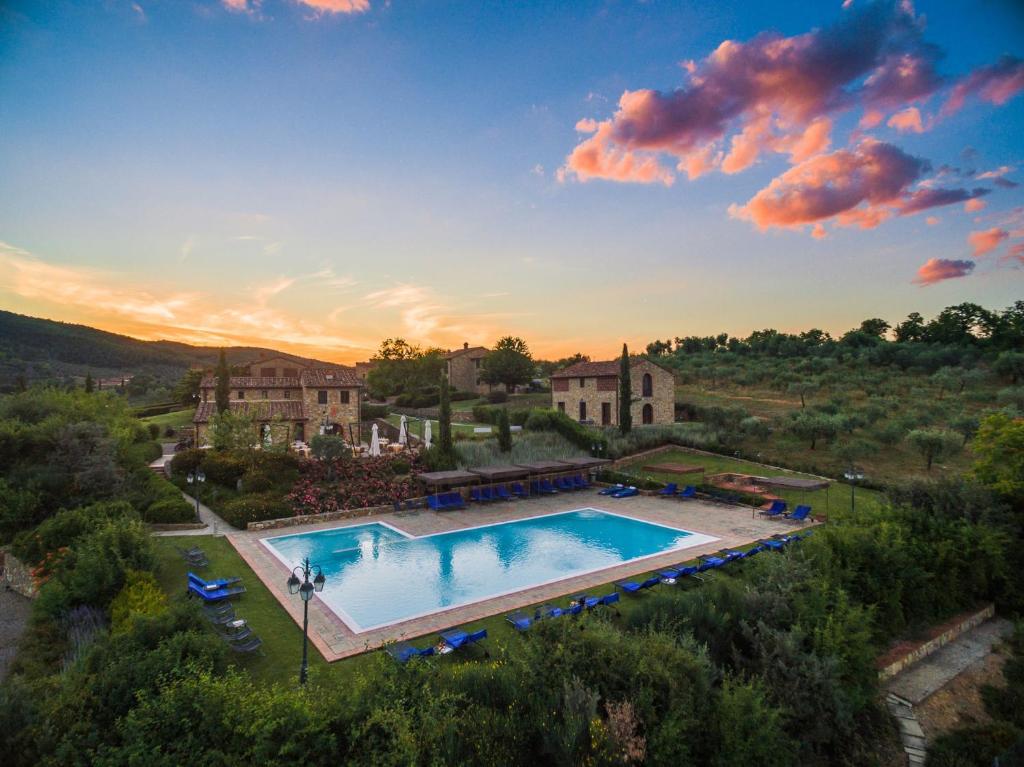 an overhead view of a large swimming pool in front of a house at Poggio Cennina Resort in Bucine