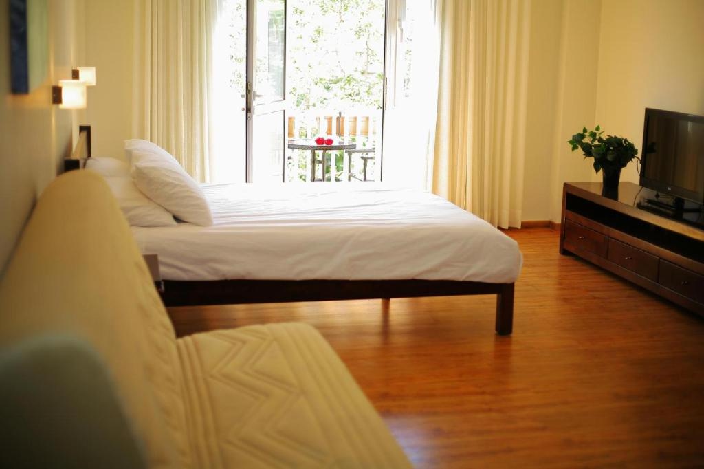 a living room with two beds and a television at Jerusalem Center Boutique in Jerusalem