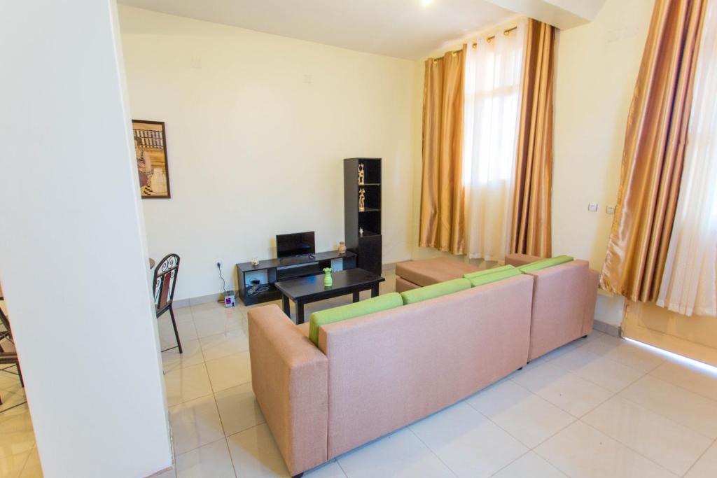 a living room with a couch and a table at Great View Apartments in Kigali
