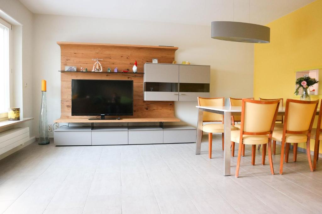 a dining room with a television and a table with chairs at Konstanz in Konstanz