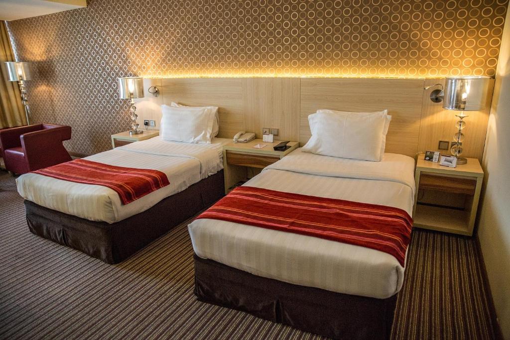 Postel nebo postele na pokoji v ubytování Saffron Boutique Hotel