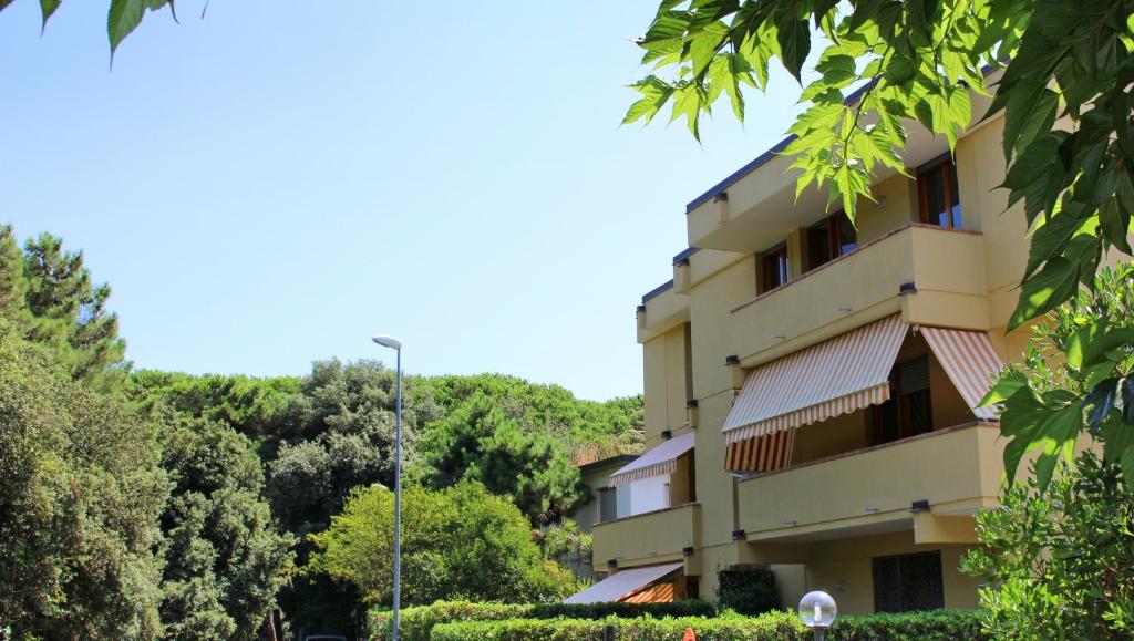 a building with trees in front of it at Casetta in Versilia in Viareggio