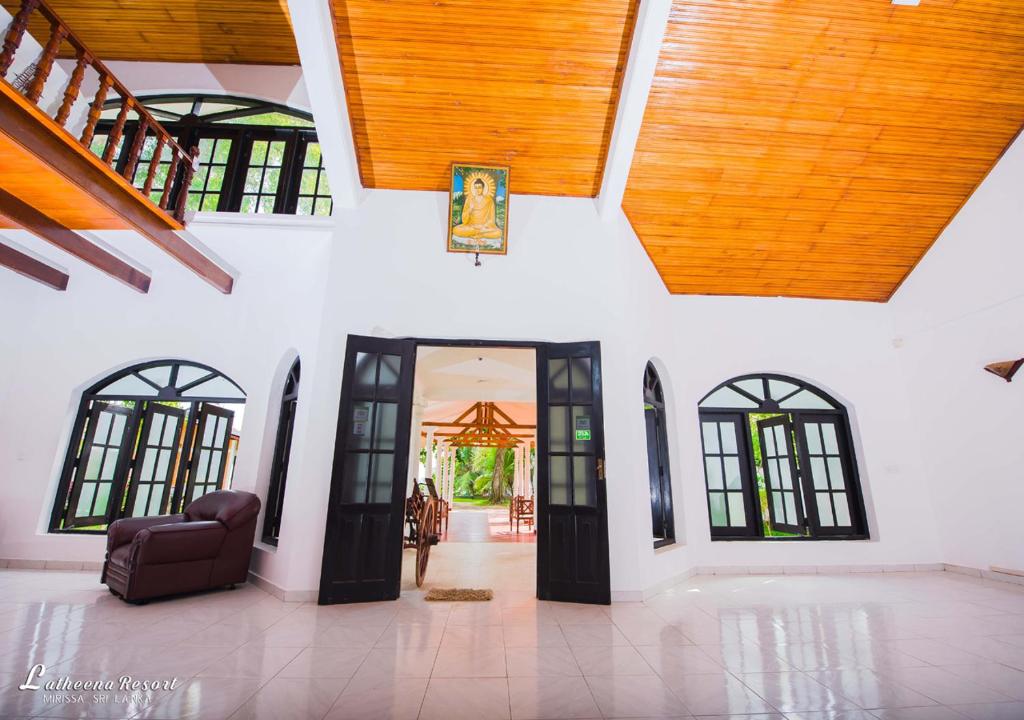 an open entry way to a house with a ceiling at Latheena Resort in Weligama