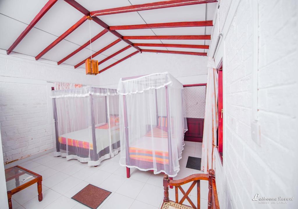 Postel nebo postele na pokoji v ubytování Latheena Resort