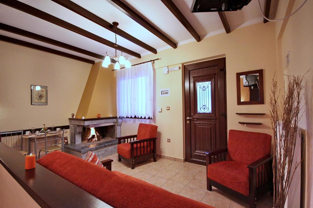 a living room with a couch and a fireplace at Melivoia in Vitina