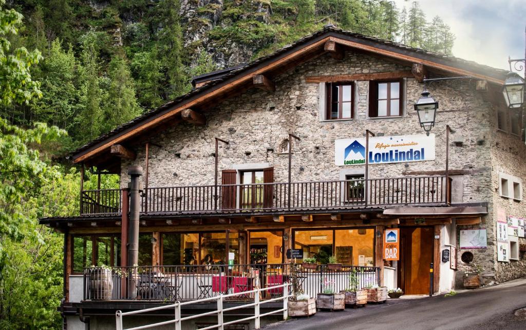 a building with a balcony on the side of it at Rifugio Lou Lindal in Canosio