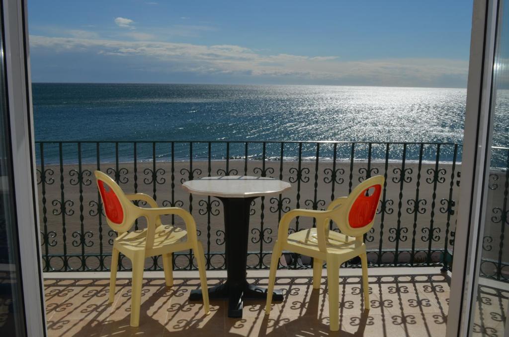 a table and two chairs on a balcony with the ocean at Plazamar in Torremolinos