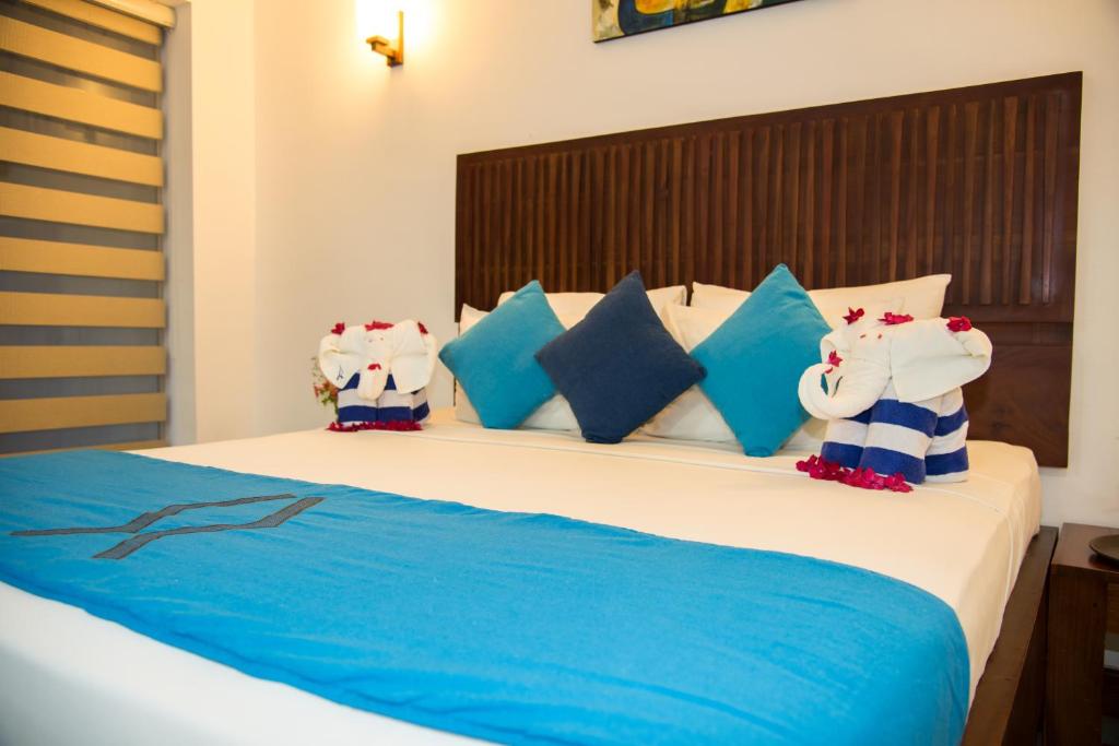 Rúm í herbergi á Anantamaa Hotel