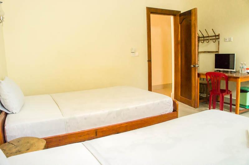 Postel nebo postele na pokoji v ubytování Visal Sak Guesthouse