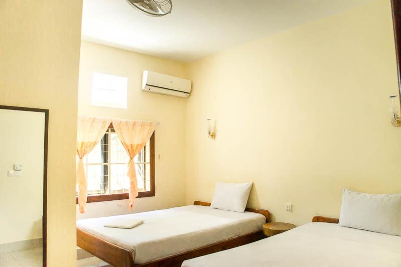 Postel nebo postele na pokoji v ubytování Visal Sak Guesthouse