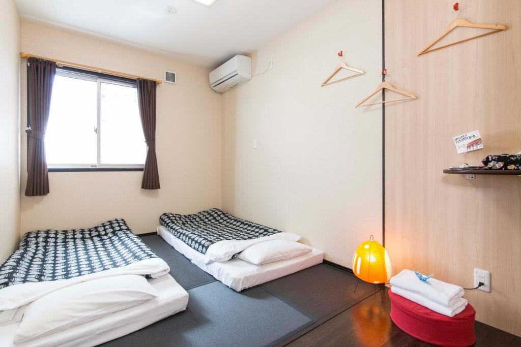 Postel nebo postele na pokoji v ubytování Fujitaya BnB