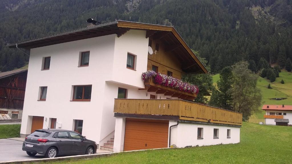 a house with a car parked in front of it at s' Ludwign Haus in Sankt Leonhard im Pitztal