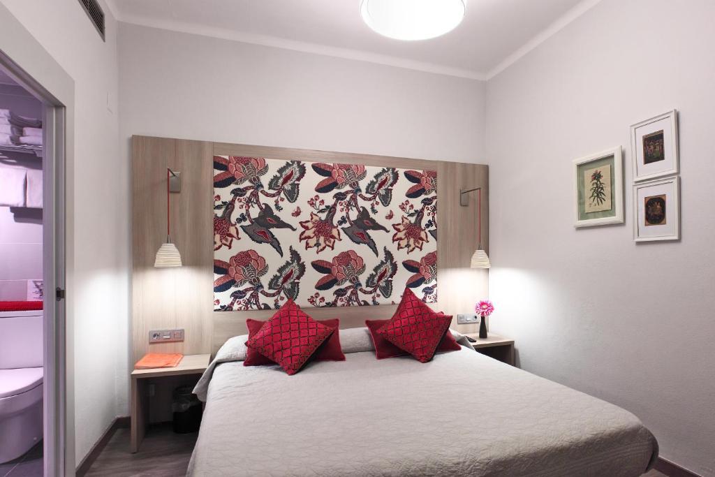 Posteľ alebo postele v izbe v ubytovaní Hotel Ginebra
