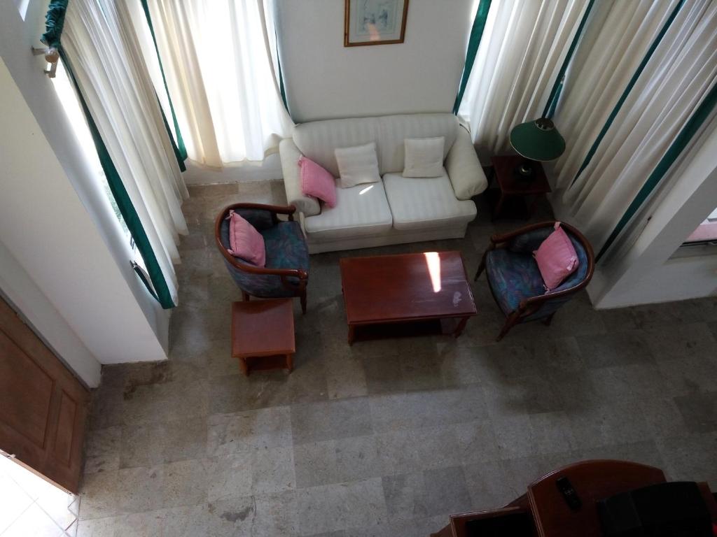 an overhead view of a living room with a couch and chairs at Admiral Villa in Carita