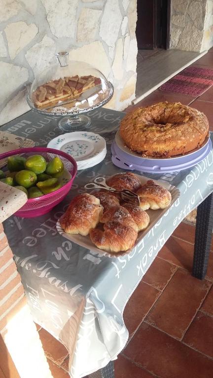 a table with pies and other food on it at Casale Del Borgo in Hermada