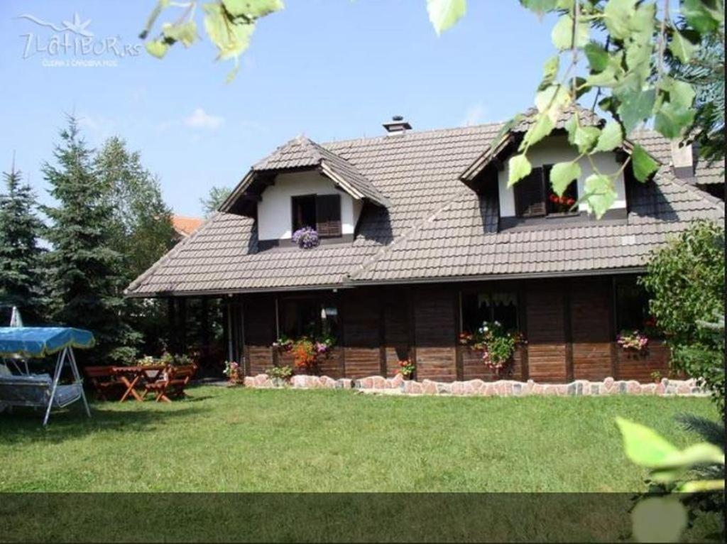 a house with a large yard in front of it at Guest House Alpska Vila in Zlatibor