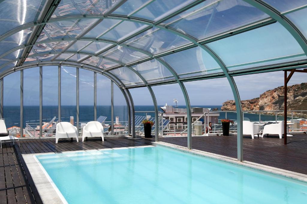 a swimming pool on the deck of a cruise ship at Hotel Praia in Nazaré