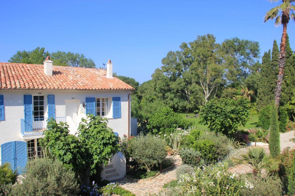 a house with a garden in the foreground at La Bastide des Salins in Saint-Tropez