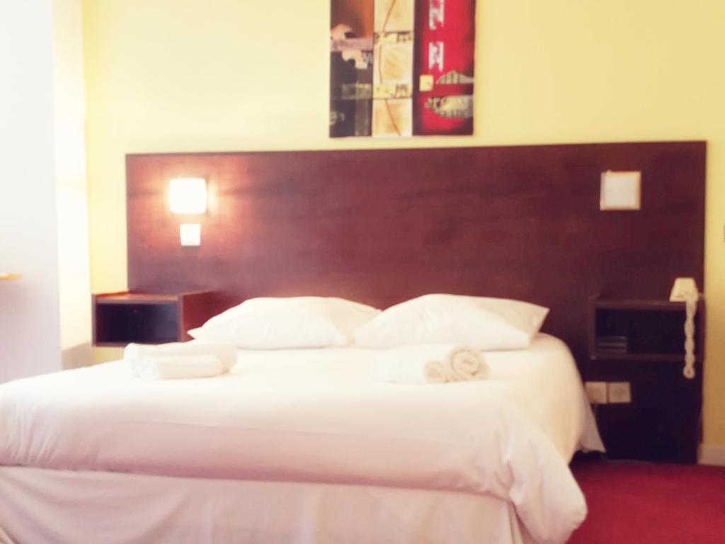 
Un ou plusieurs lits dans un hébergement de l'établissement Hôtel Des Lilas
