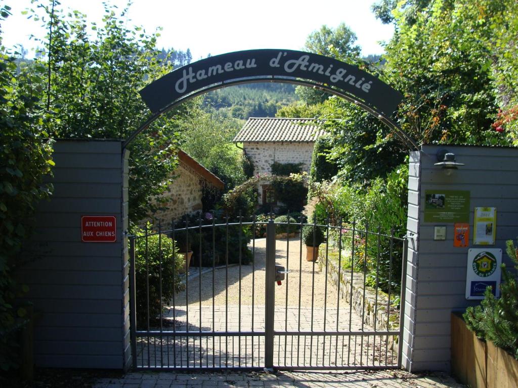 an entrance to a garden with an iron gate at Gite du Hameau D'Amignié in Vernay