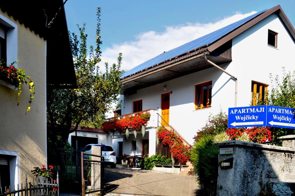 a building with a sign on the side of it at Apartments Wojcicky in Bovec